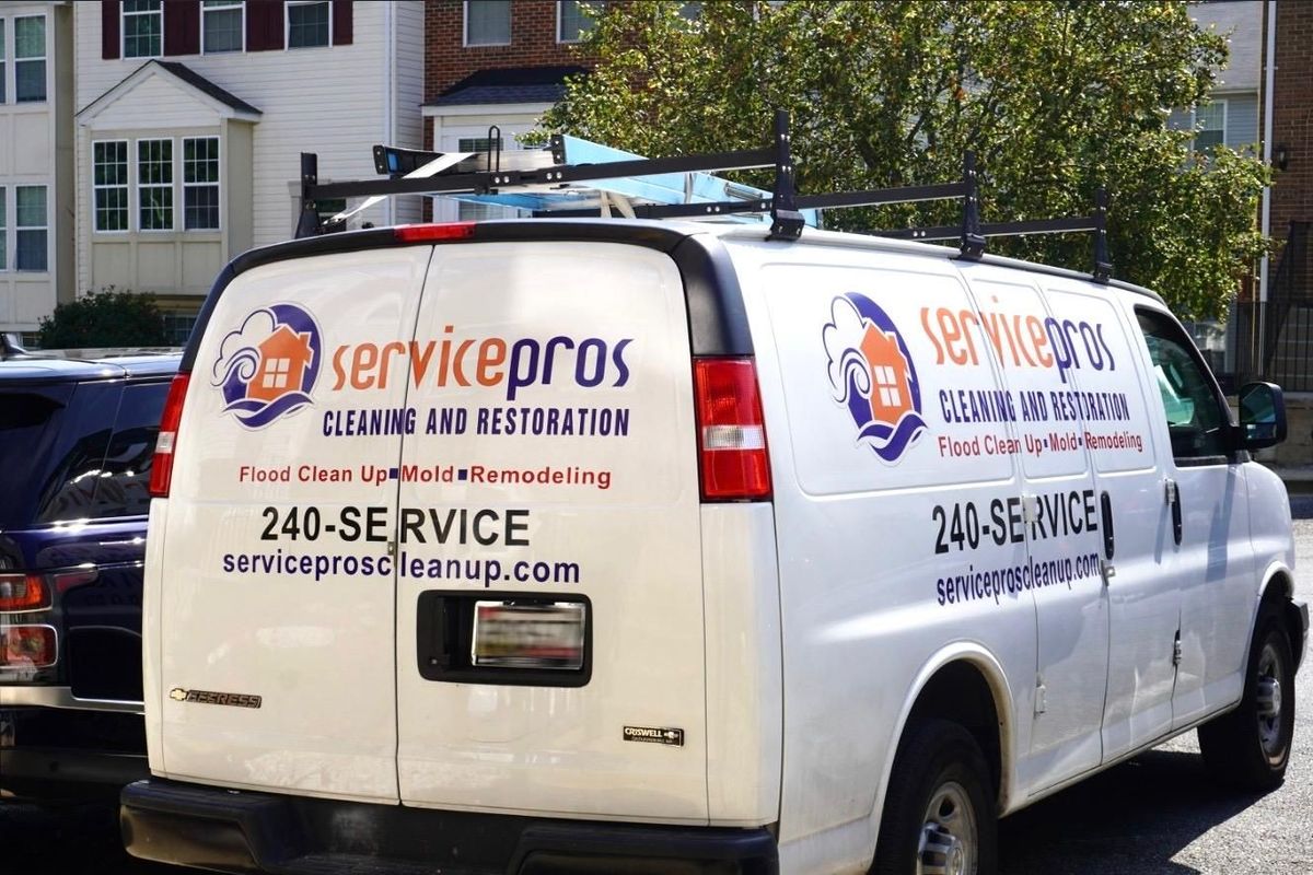 ServicePros branded restoration van parked outside a Maryland property