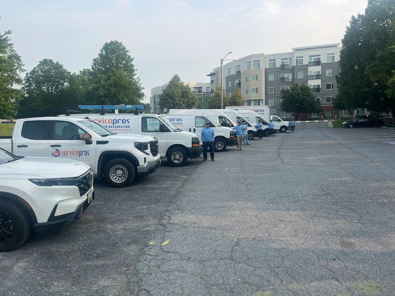 ServicePros fleet of white branded vans lined up in a parking lot